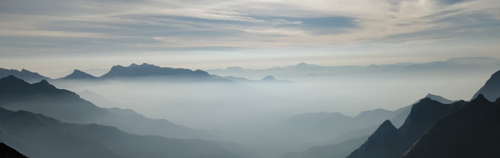 mountains under white clouds during daytime