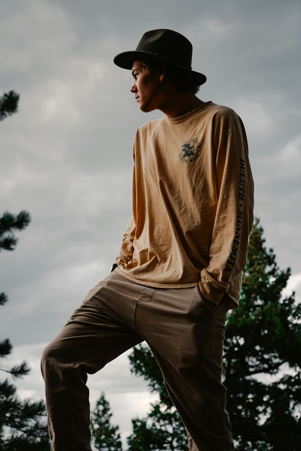 Man in brown long sleeve shirt and brown pants standing under white sky  during daytime photo – Free Fashion Image on Unsplash