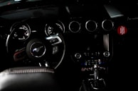 Interior shot highlighting a 2008 Mustang’s dashboard with aftermarket gauges.