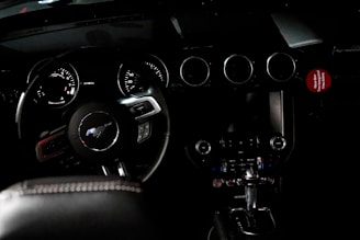 Interior shot highlighting a 2008 Mustang’s dashboard with aftermarket gauges.