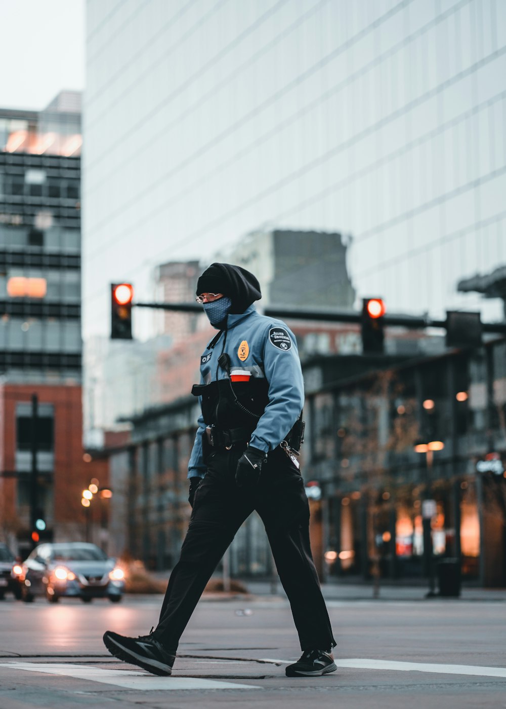man in black jacket and black pants wearing black cap walking on street during daytime