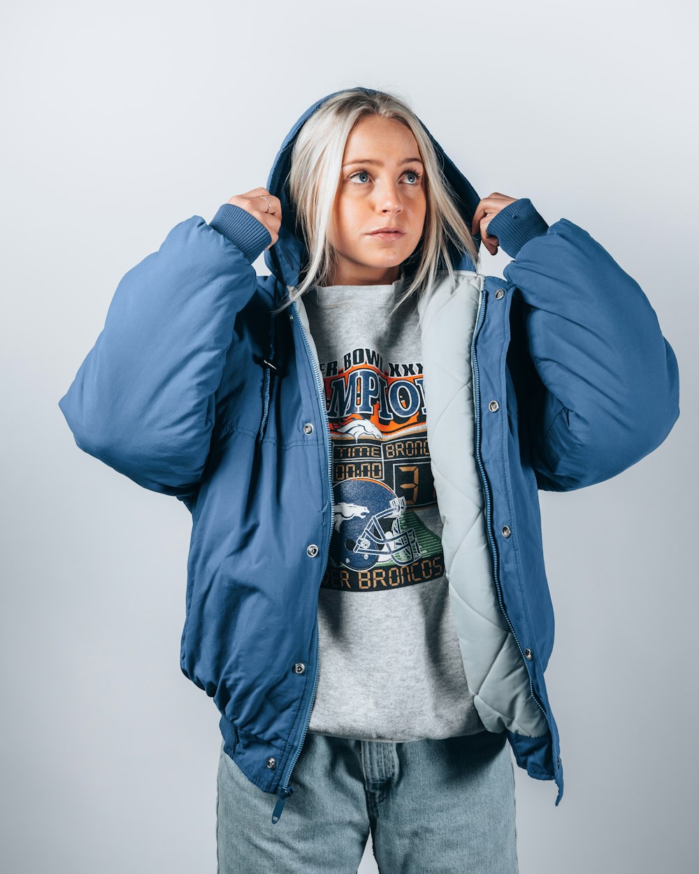 woman in blue jacket standing and smiling