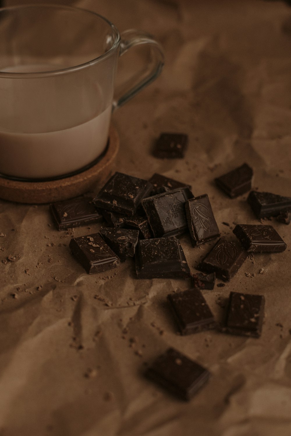 clear glass mug beside brown chocolate bar