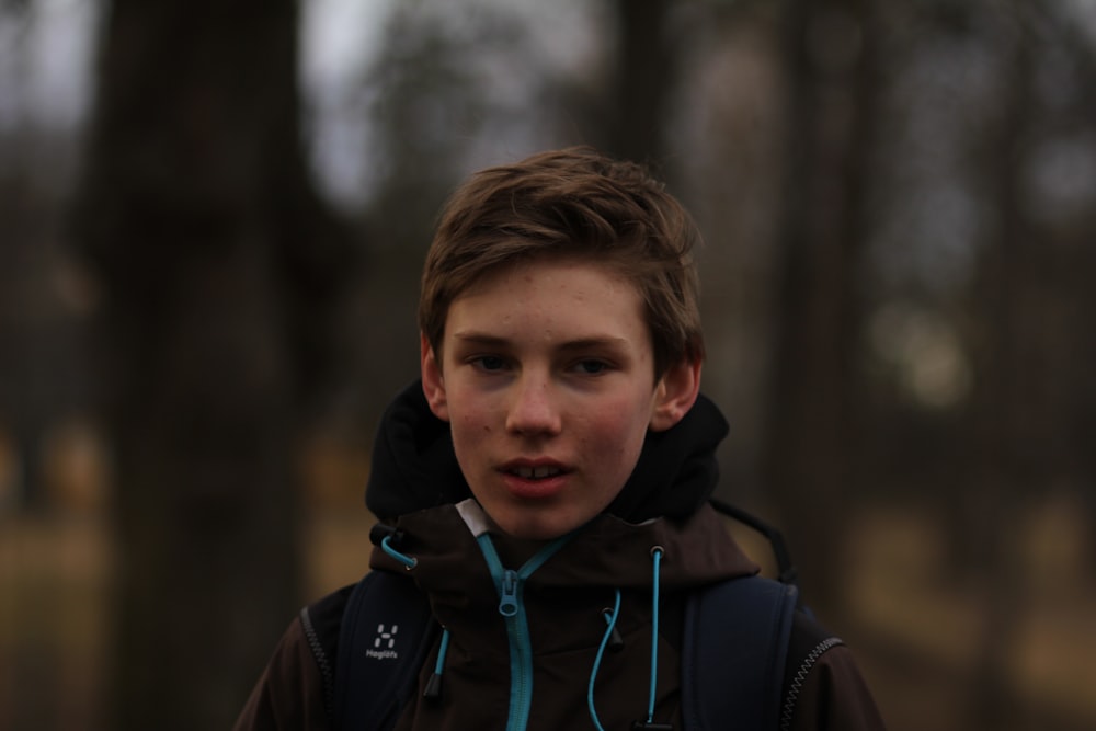 boy in black and blue zip up jacket