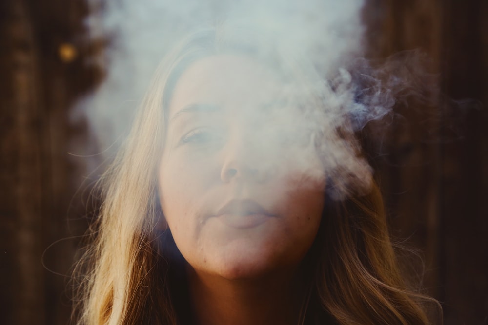 woman with white smoke on her face