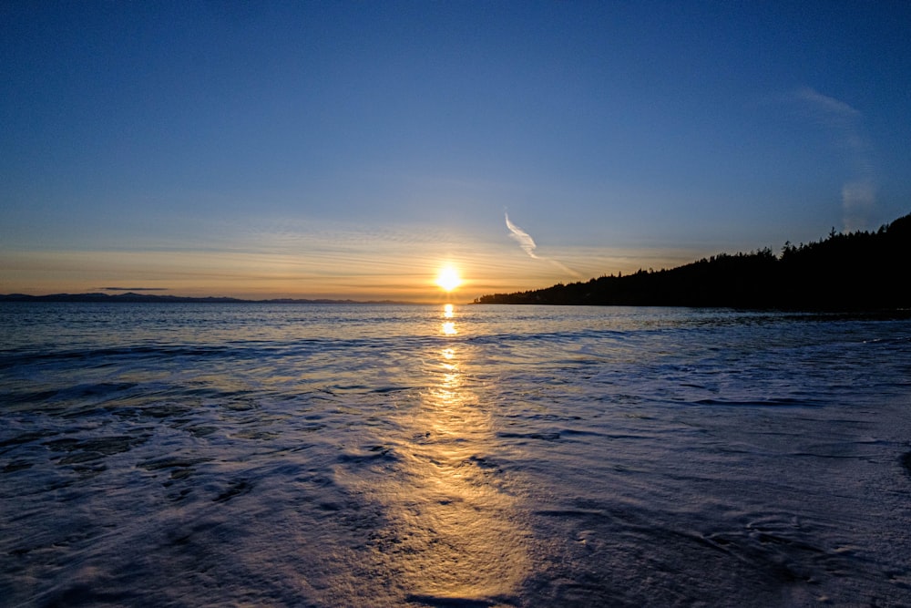 body of water during sunset