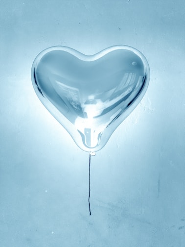 A charming bubble balloon with a heartfelt message floating gently indoors.