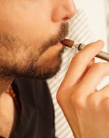 man in black shirt smoking cigarette