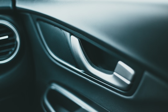 Close-up of a 3D modeled car door showing intricate textures and reflections.