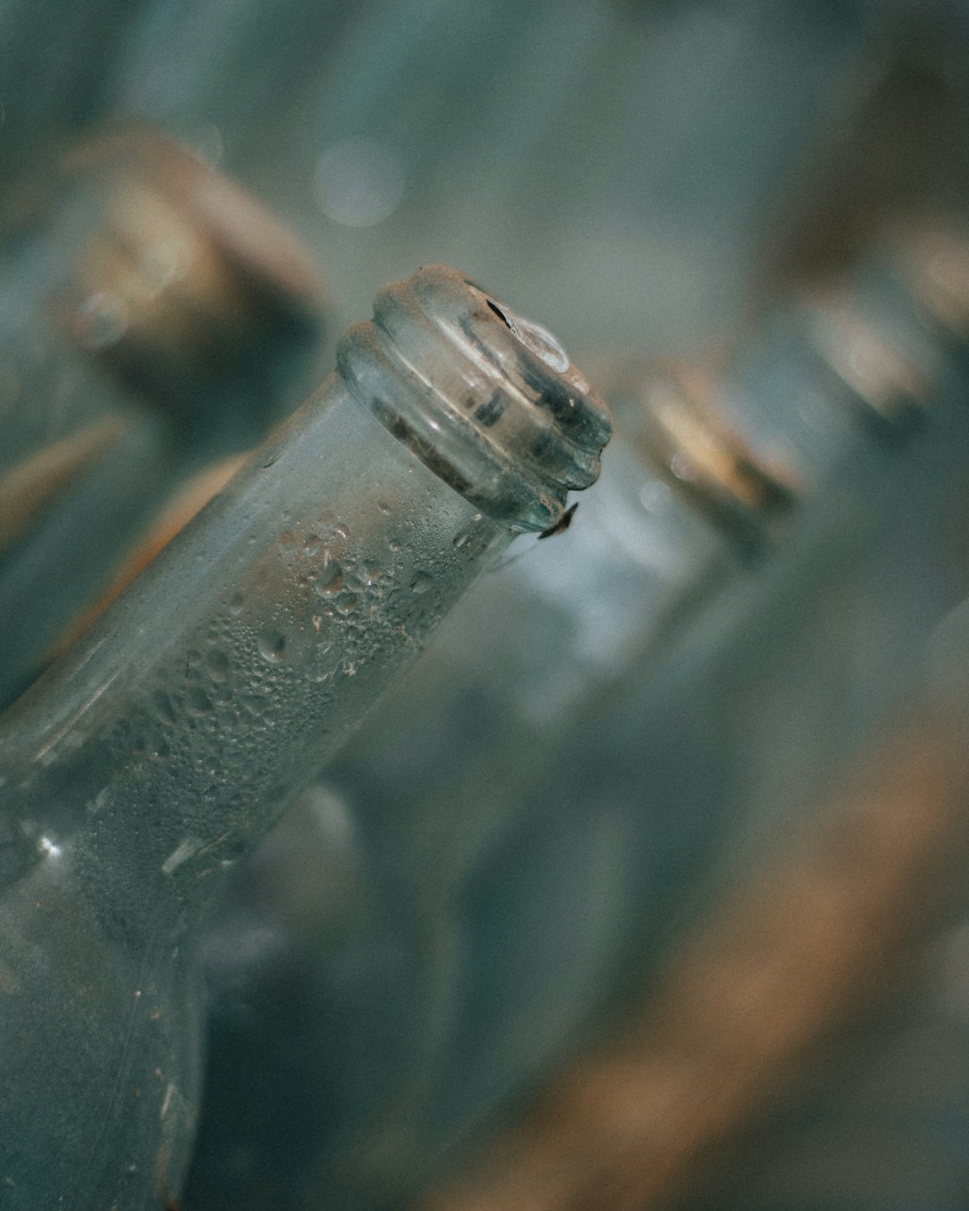 water droplets on clear glass bottle