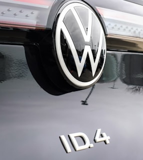 Volkswagen ID.6 parked by the Durrës coastline at sunset, highlighting its sleek design and spaciousness.