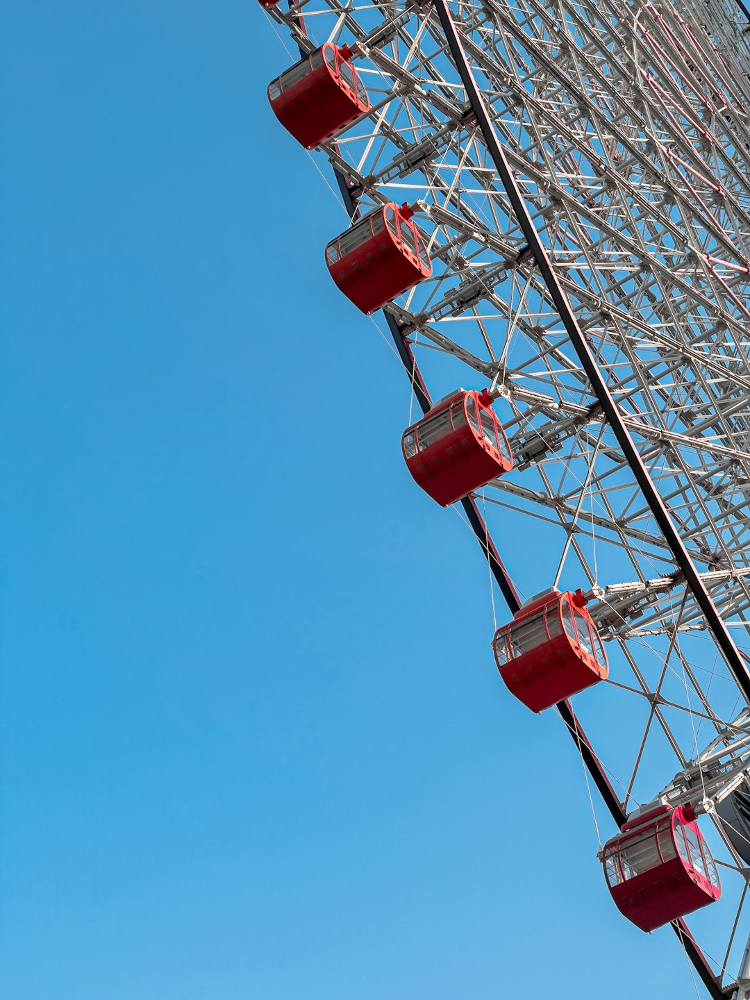 red and gray ferris wheel under blue sky during daytime