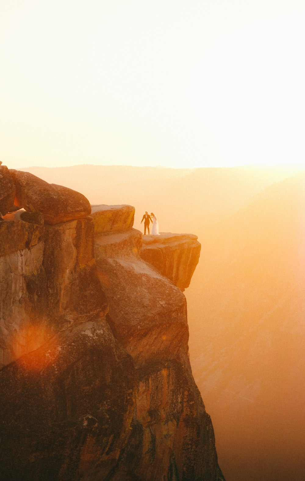 person standing on brown rock formation during daytime