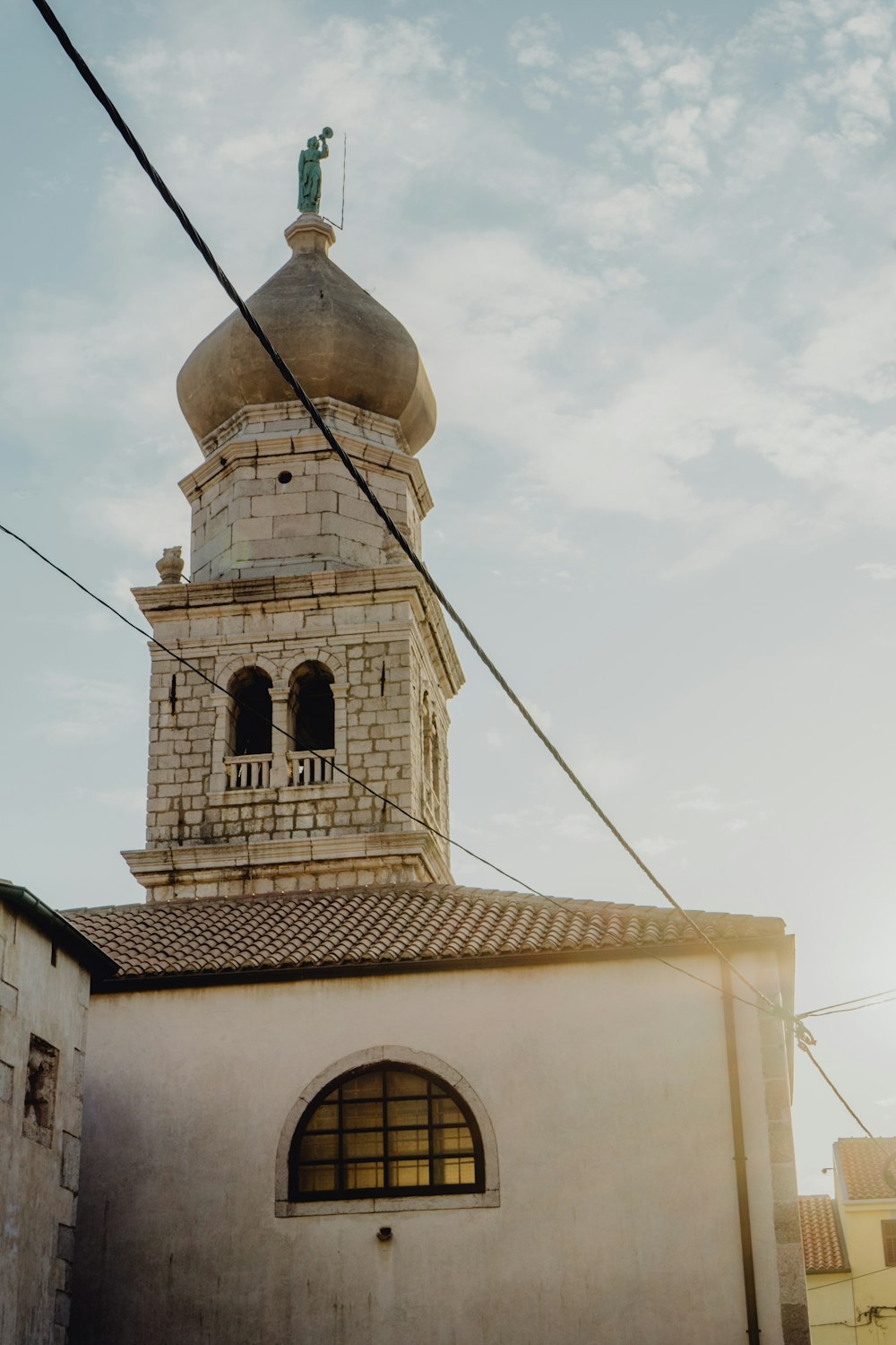 a tall white building with a clock on it's side