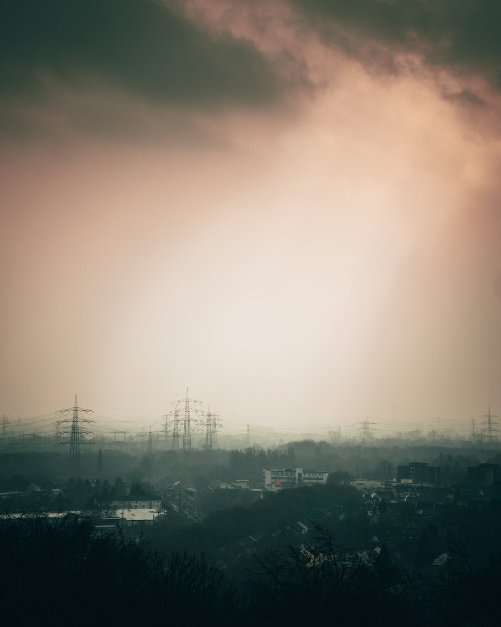 city with high rise buildings under white sky during daytime