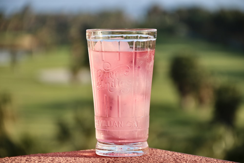 clear drinking glass with red liquid