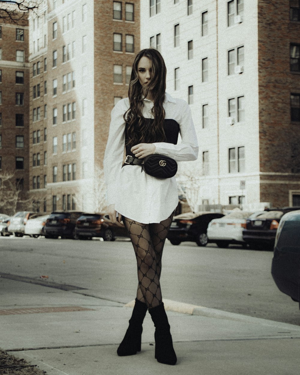 woman in white long sleeve shirt and red skirt standing on pedestrian lane during daytime