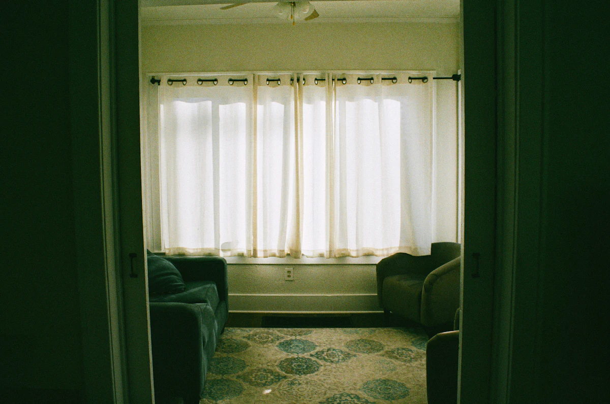 Custom-made curtains fitted to a window in a decorated room