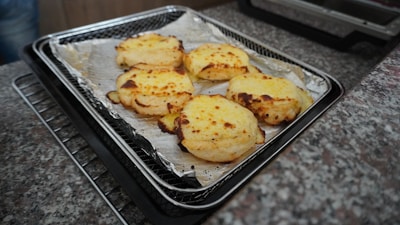 Various baking pans and trays neatly arranged on a rustic wooden table