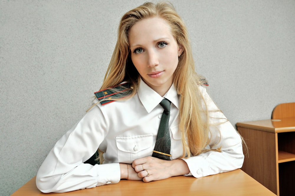 woman in white blazer sitting on chair