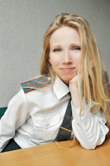 woman in white blazer smiling