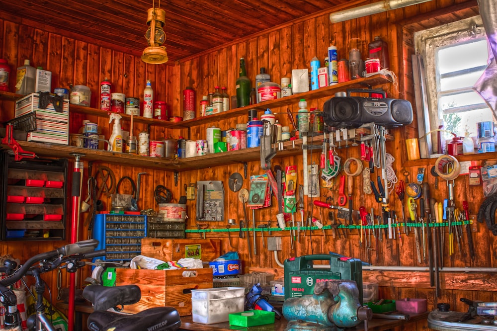 assorted tools on brown wooden shelf