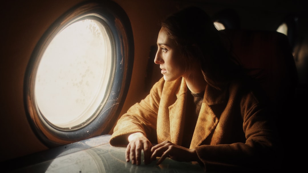 woman in brown coat sitting on chair