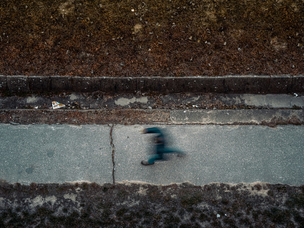 blue and black plastic toy on gray concrete floor