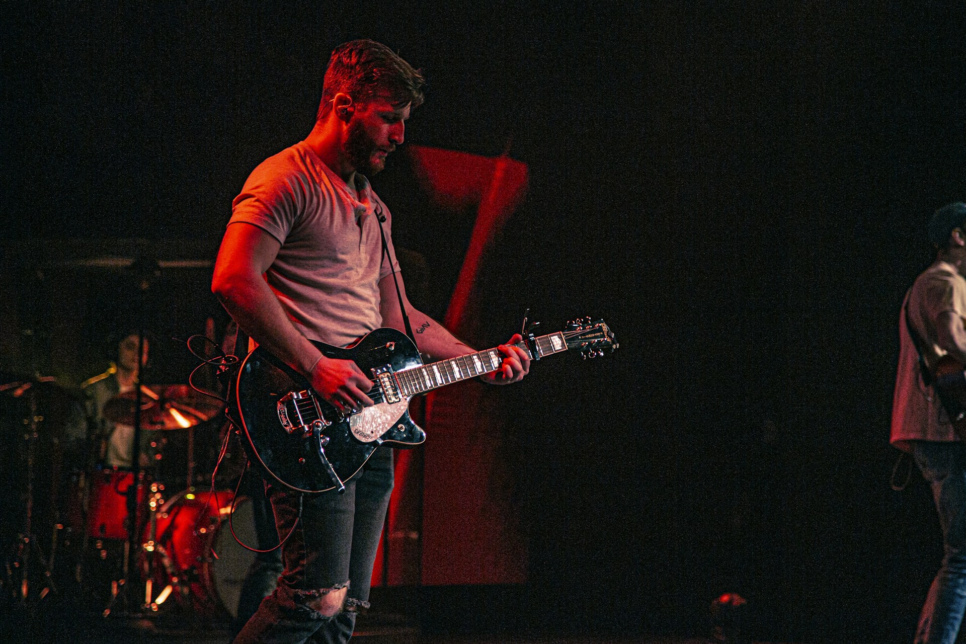 Close-up of a musician passionately playing a guitar at a private event, warm lighting highlighting the moment.