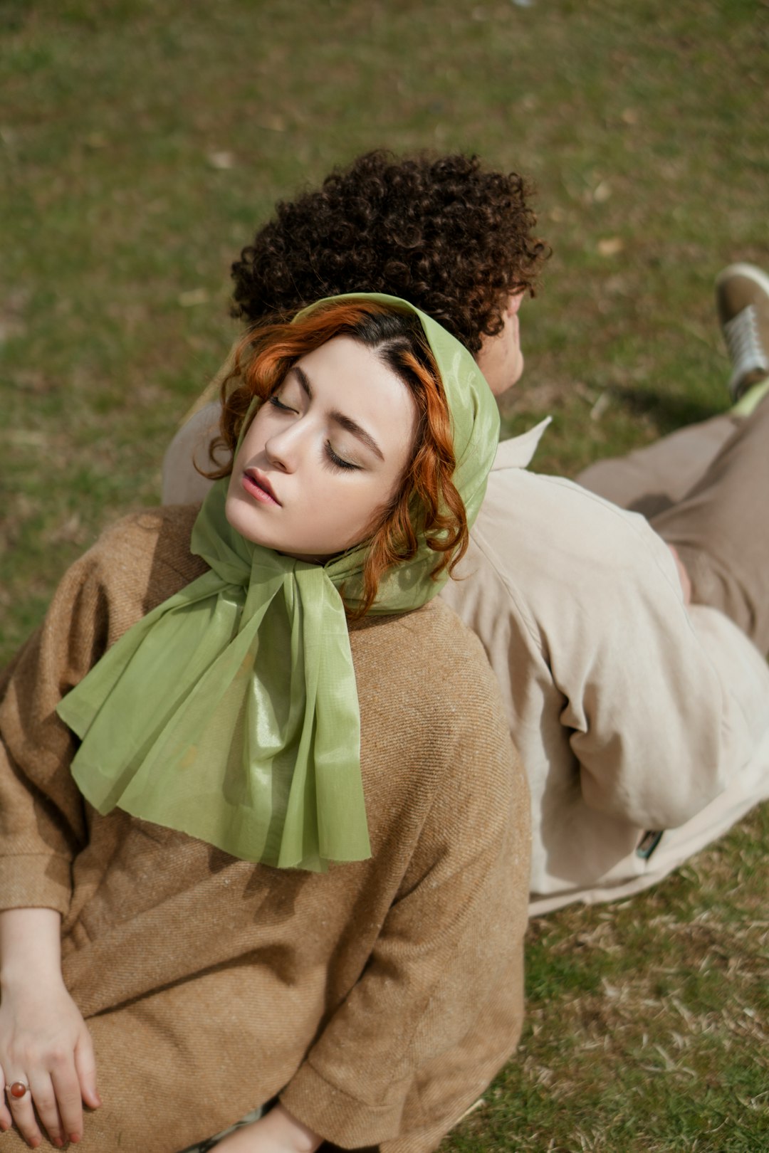 woman in white long sleeve shirt and green scarf