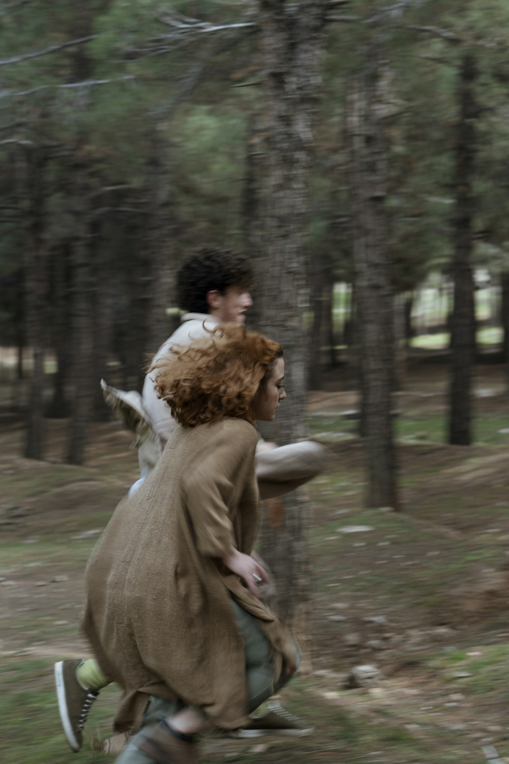 woman in brown coat walking on pathway