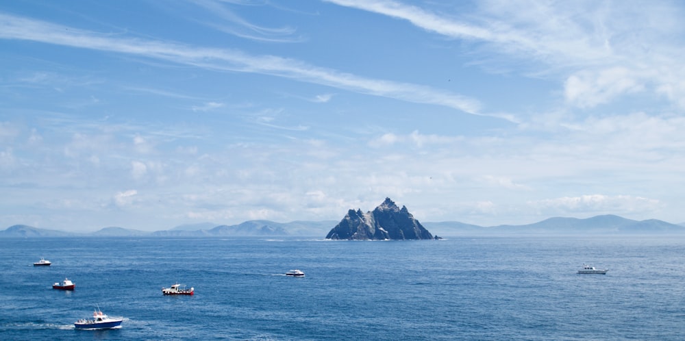 boat on sea under blue sky during daytime