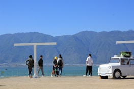 Group of travelers enjoying a panoramic view from a mountain lookout.