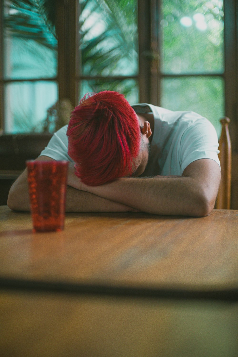 man in white t-shirt sitting at the table