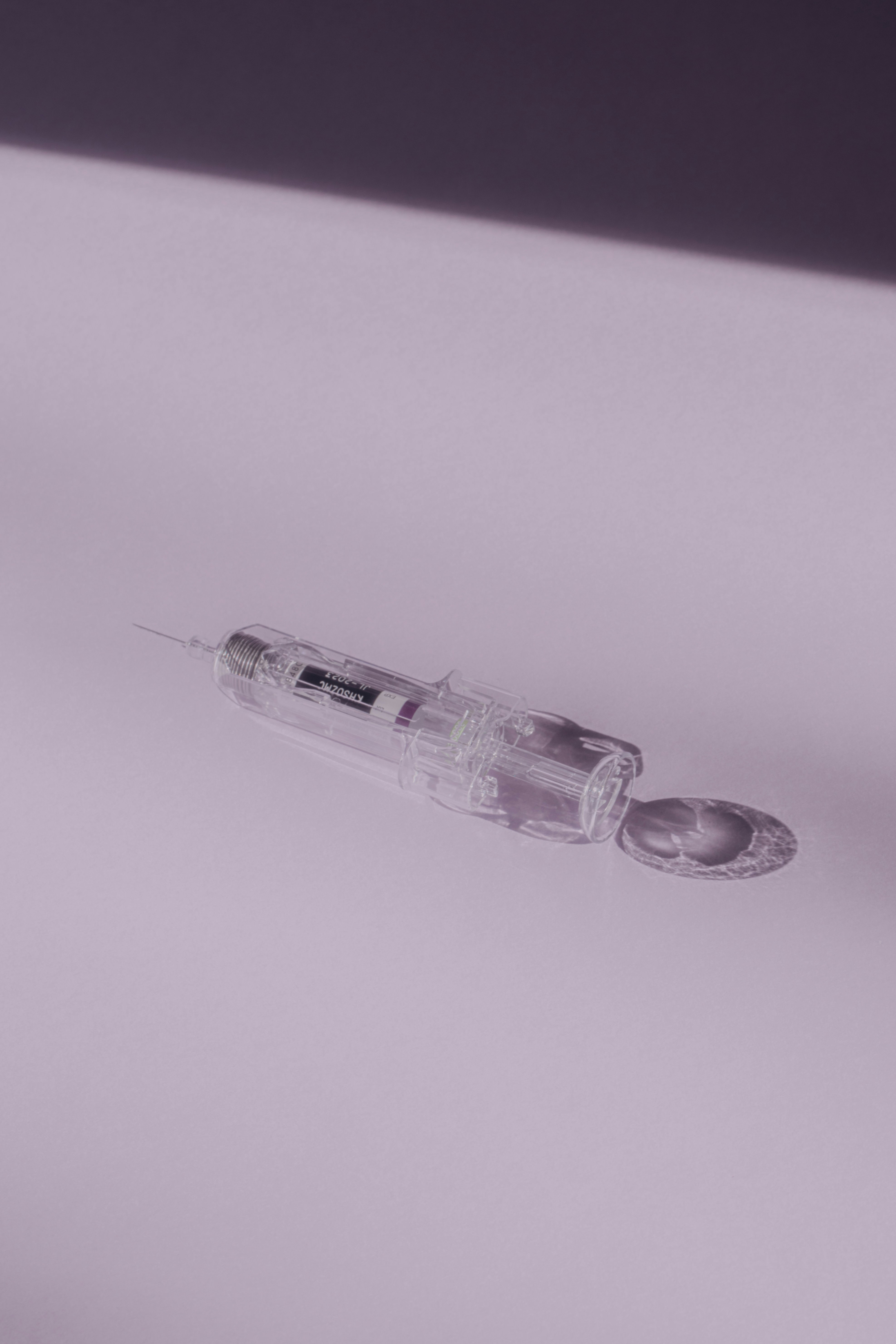 clear glass syringe on white surface