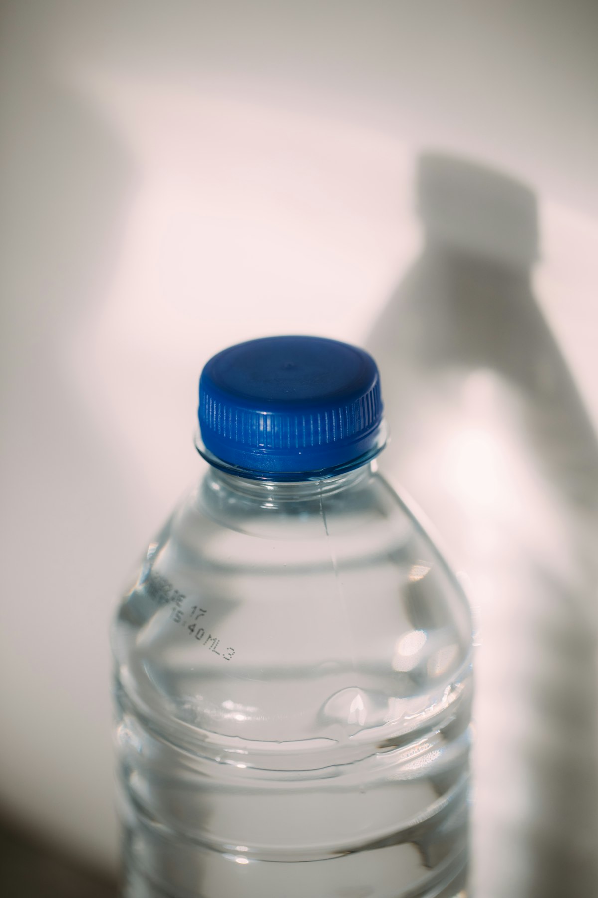 Refillable water gallons neatly stacked ready for delivery at a water refill depot