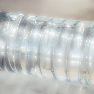 clear plastic bottle on white table