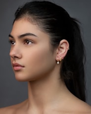 woman with silver and diamond stud earrings
