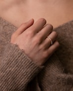 person wearing gold ring on left ring finger