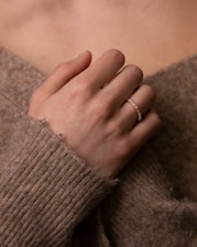 person wearing gold ring on left ring finger