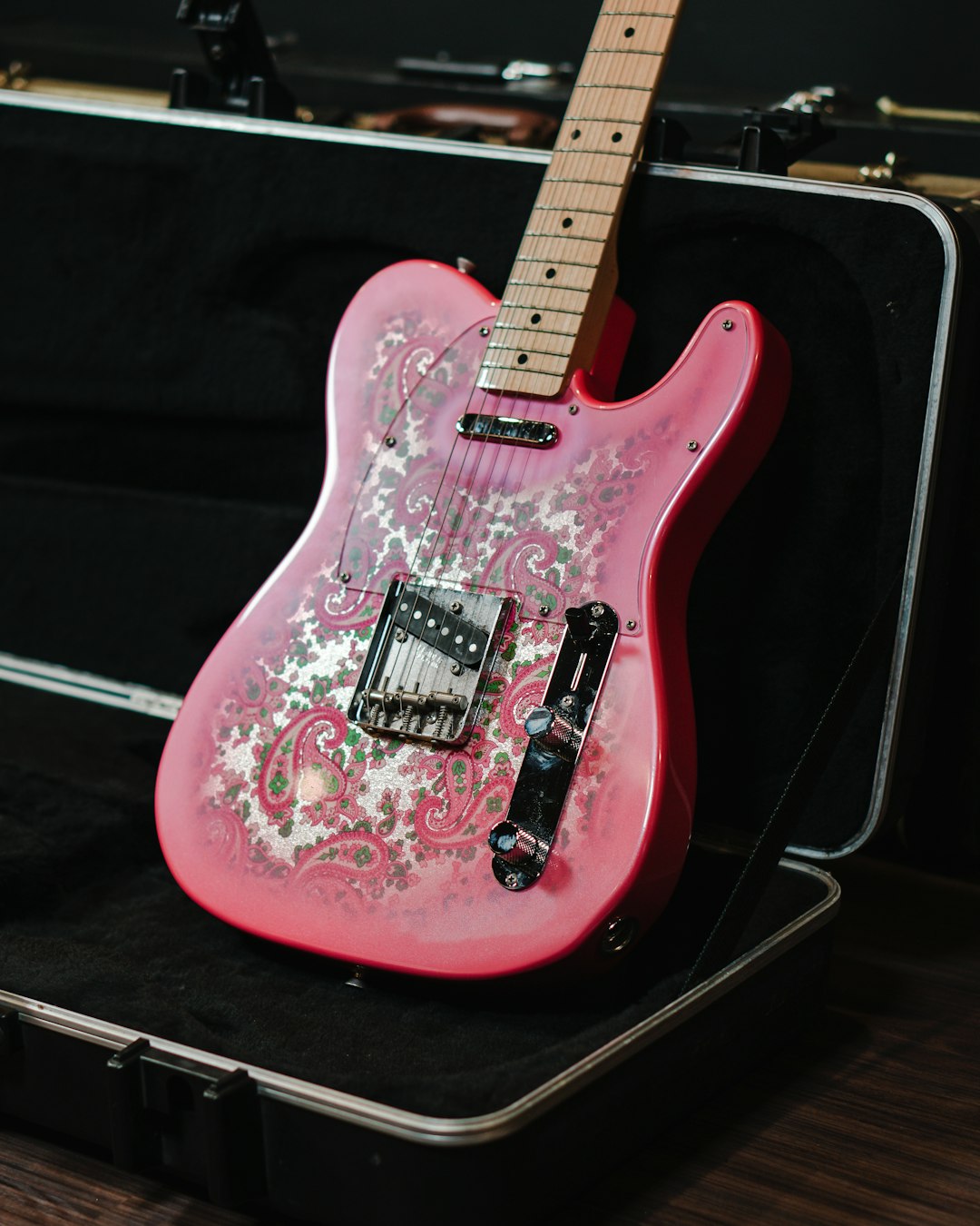 pink and white stratocaster electric guitar