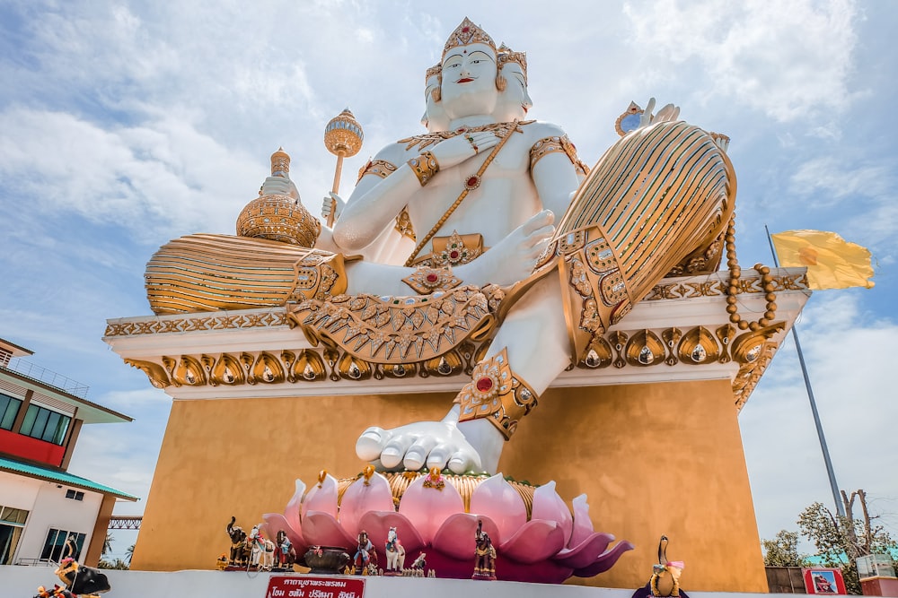 gold and pink hindu deity statue