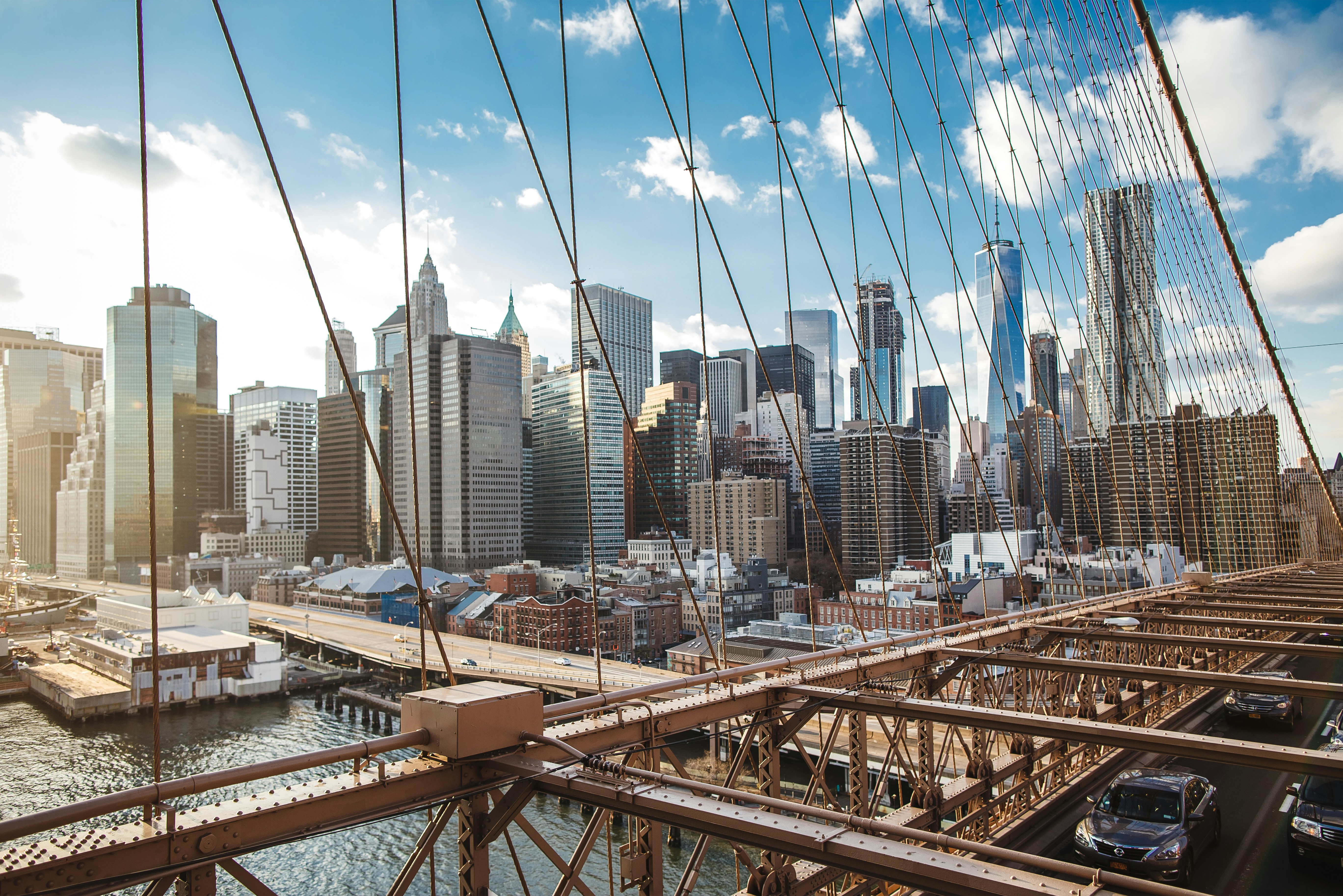 brown metal bridge over the city during daytime