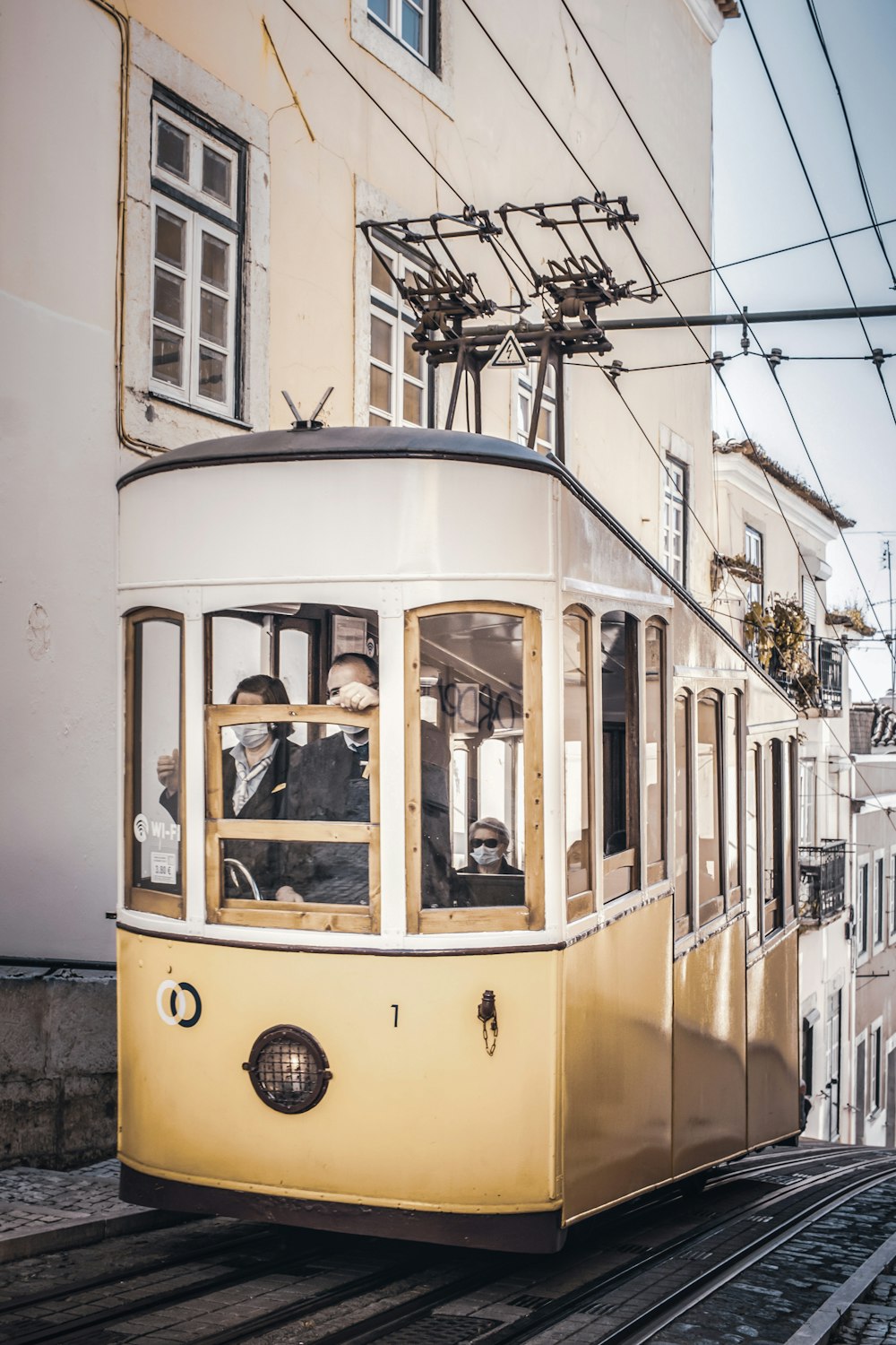 yellow and white tram on road during daytime