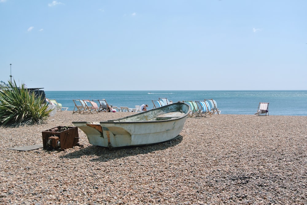 brown wooden boat on beach during daytime