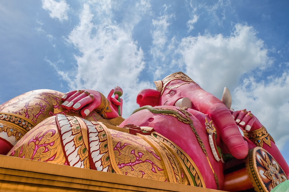 red and gold dragon statue under blue sky during daytime