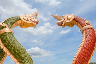 gold dragon statue under blue sky during daytime