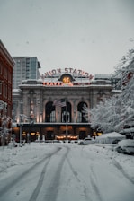 brown concrete building with snow on roof Colorado 