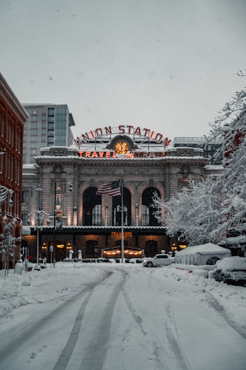 brown concrete building with snow on roof Colorado 