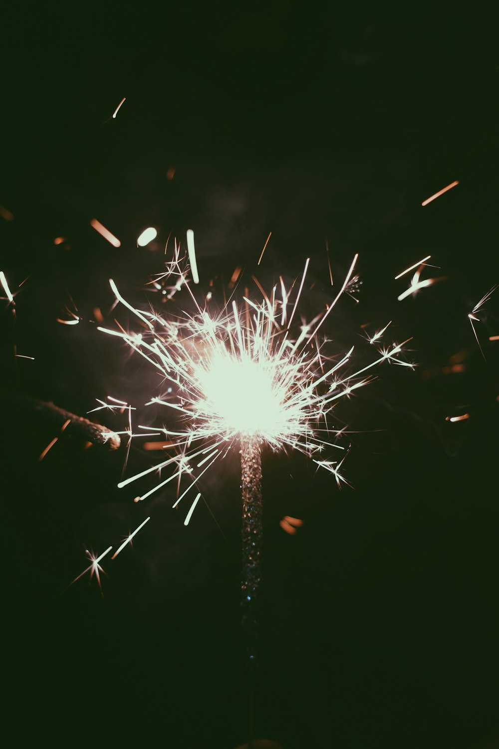 white and red fireworks in dark night sky